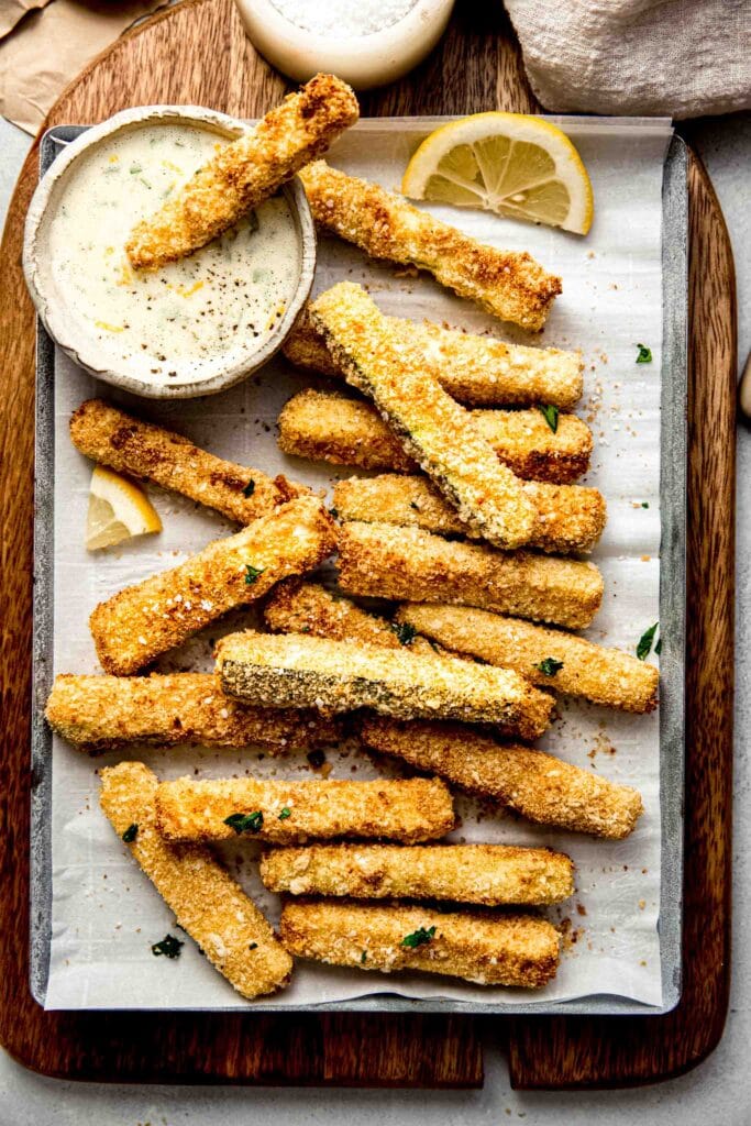 Zucchini fries arranged on serving tray. 