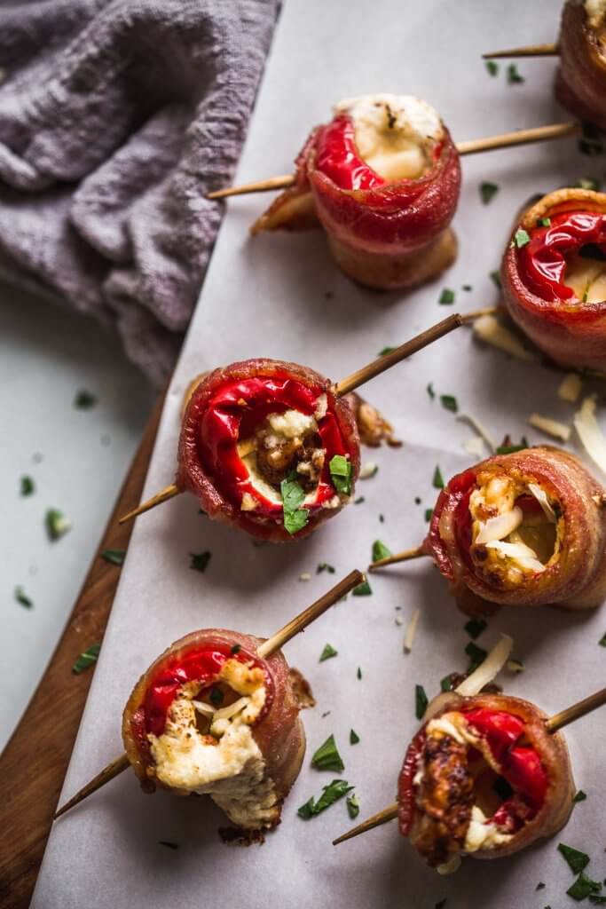 Close up of stuffed cherry peppers wrapped with bacon ready to eat.