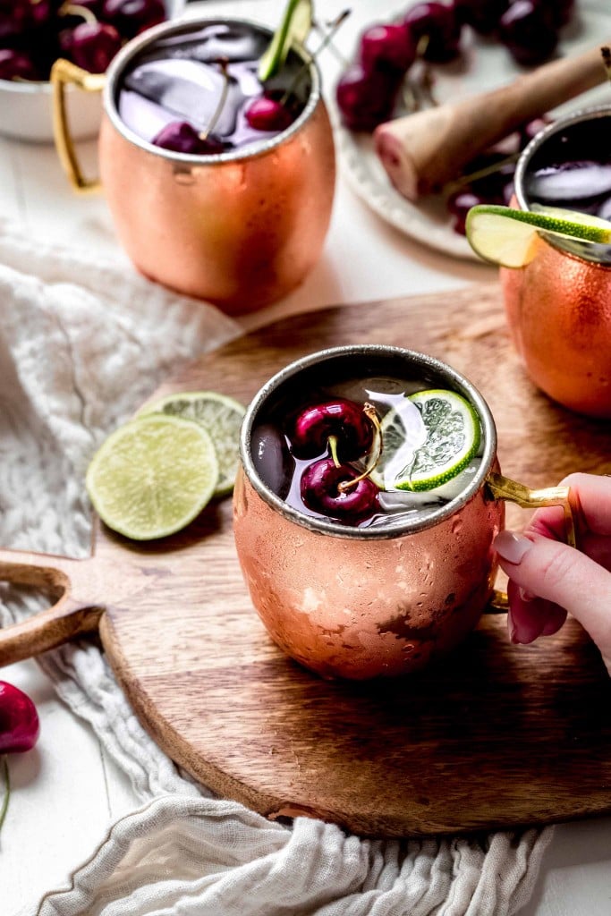 Hand holding copper mug. 