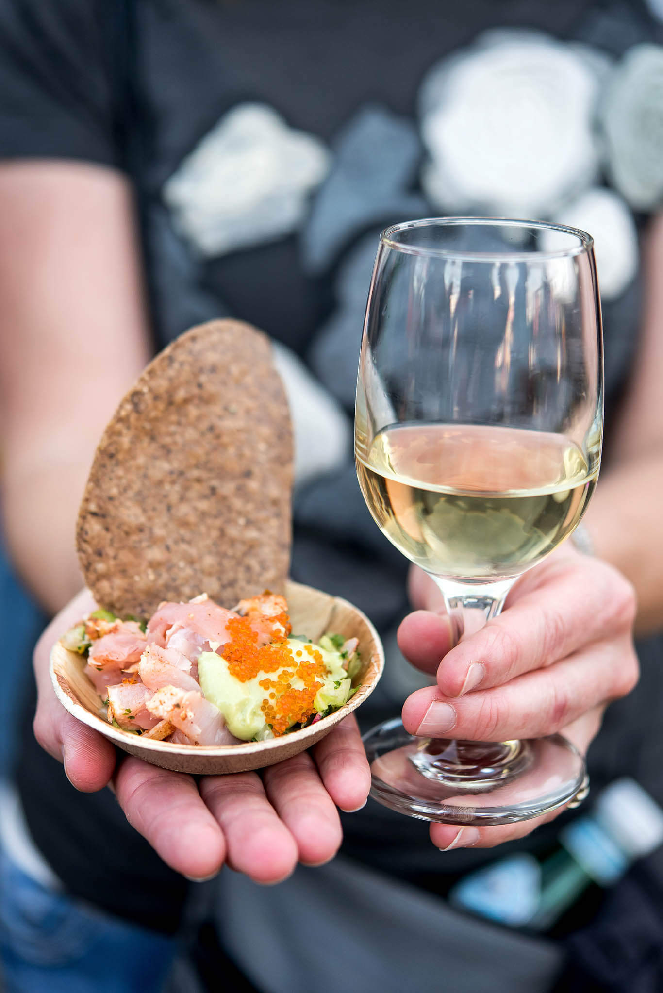 FEAST Portland - Hands holding glass of wine and small bite of ceviche