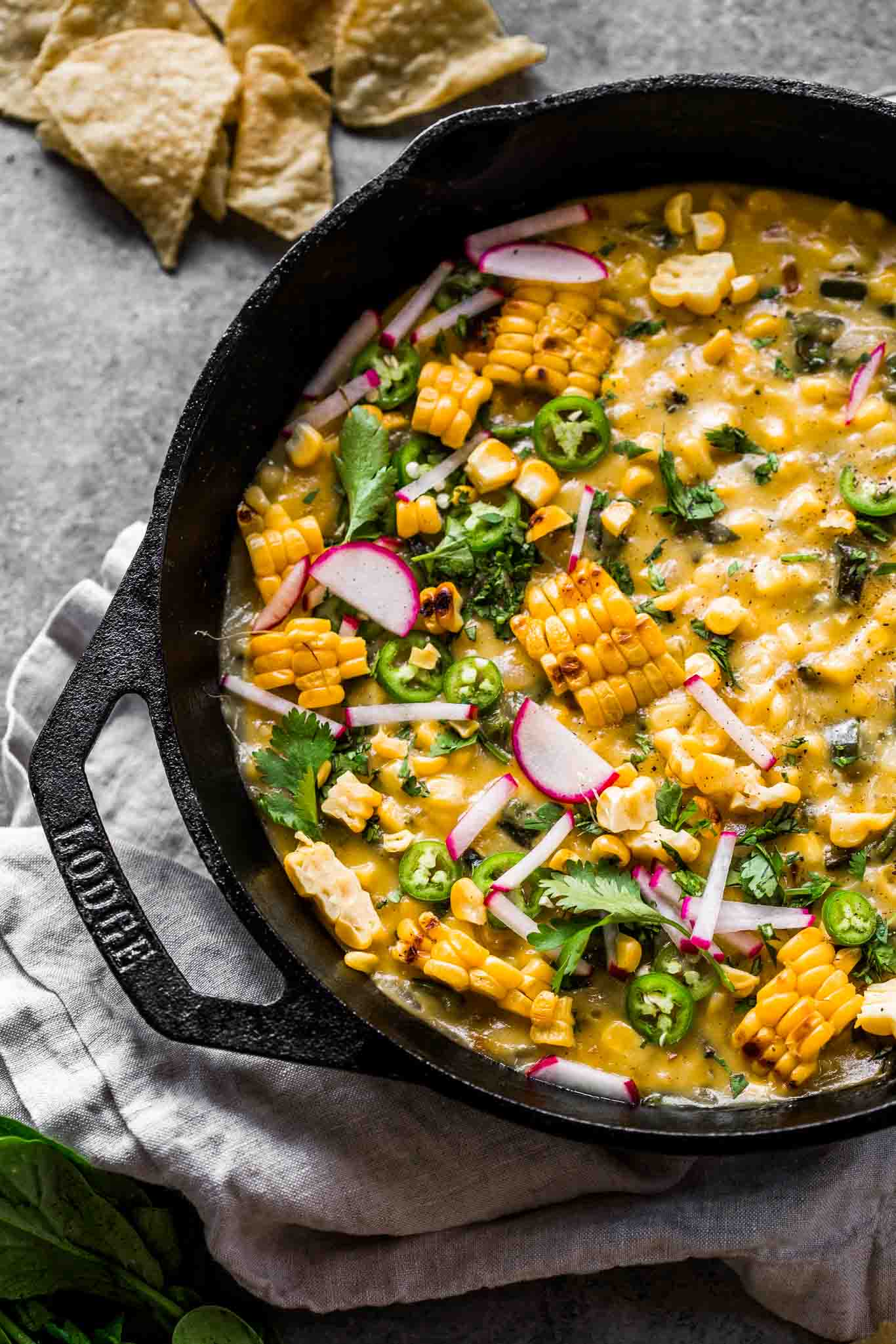 Overhead shot of corn queso dip in skillet.