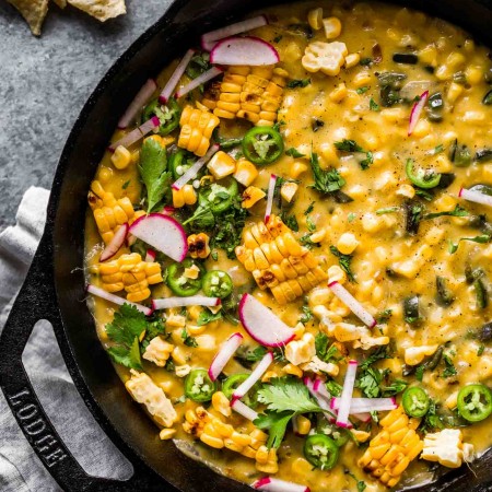 Overhead shot of corn queso dip in skillet.