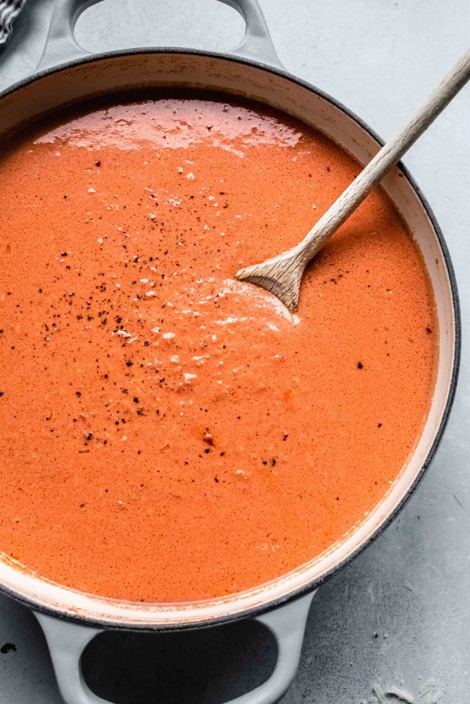 Vodka sauce in large pan with spoon. 