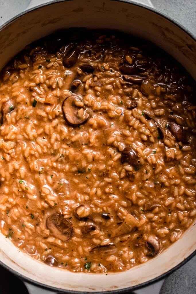 Cooked mushroom risotto in dutch oven.
