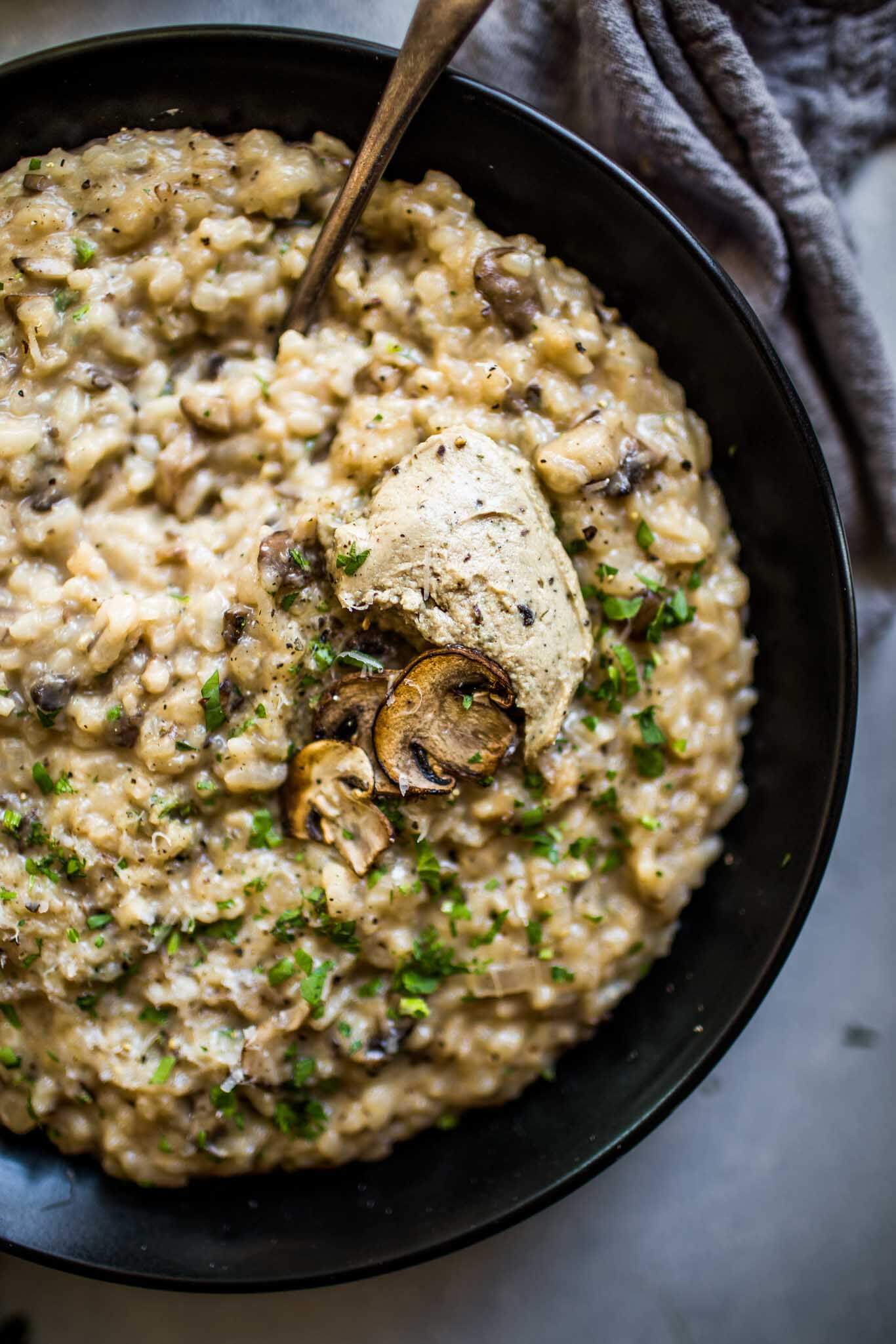 Overhead shot of mushroom risotto topped with truffle mousse.