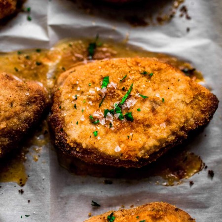 Overhead shot of baked Shake n Bake pork chops on baking sheet.