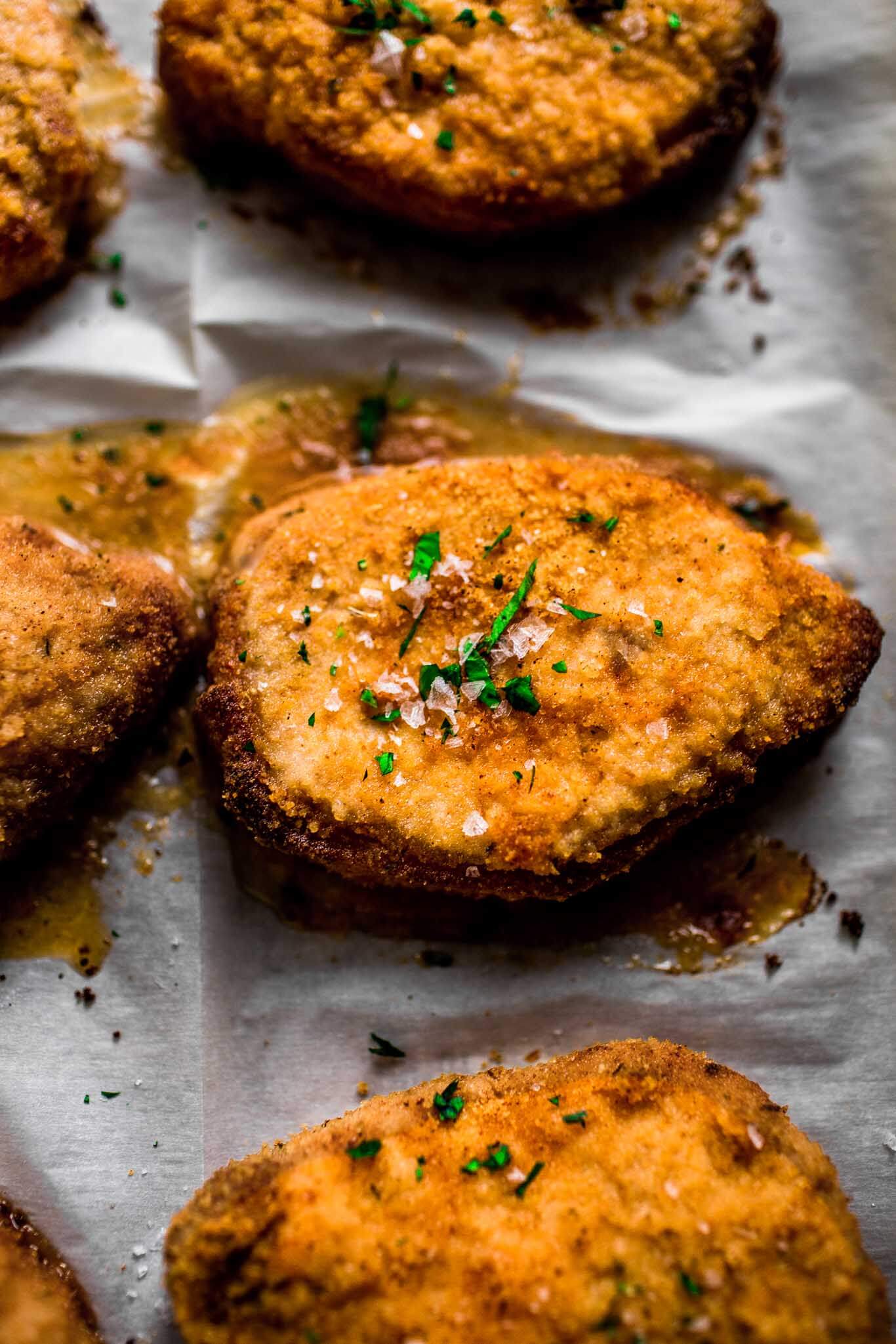 Overhead shot of baked Shake n Bake pork chops on baking sheet.