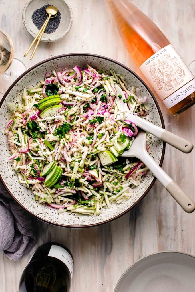 Overhead shot of celery slaw with serving spoons.