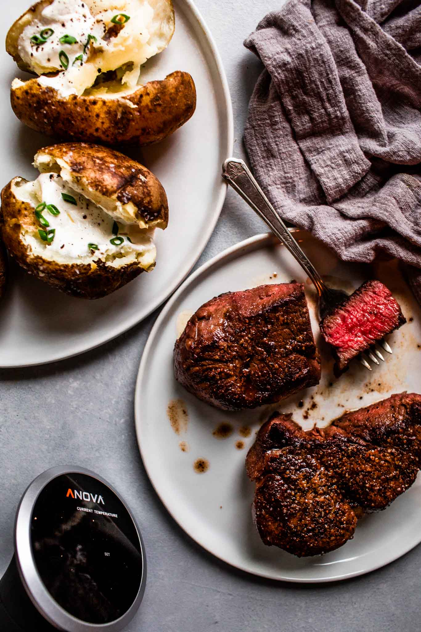 Filet mignon next to sous vide and baked potatoes. 