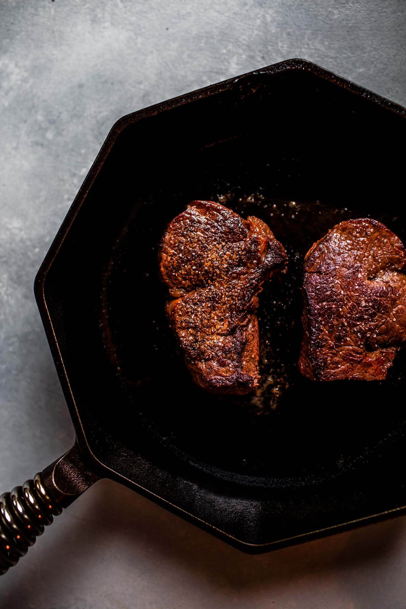 Filet mignon steaks in skillet. 