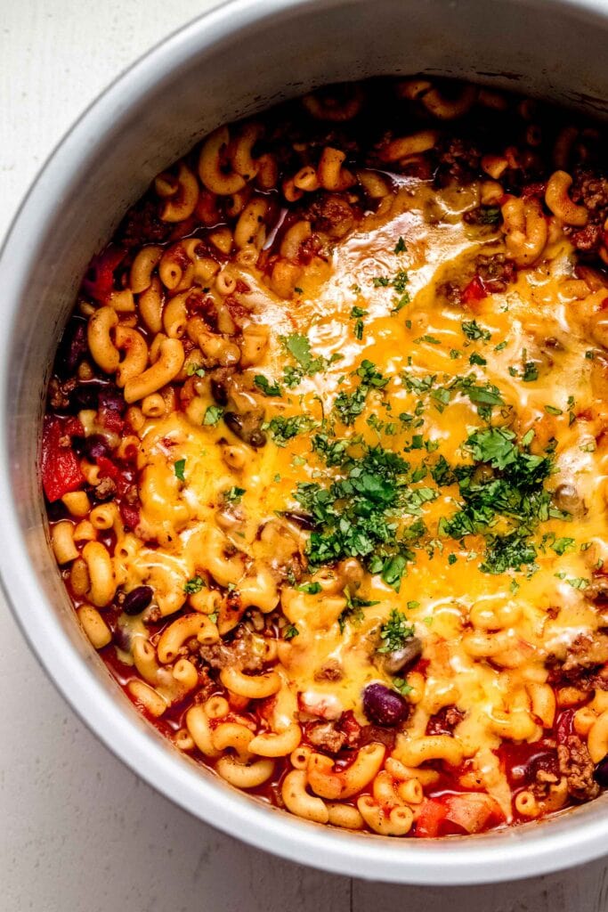 Finished chili mac in instant pot topped with cheese and cilantro.