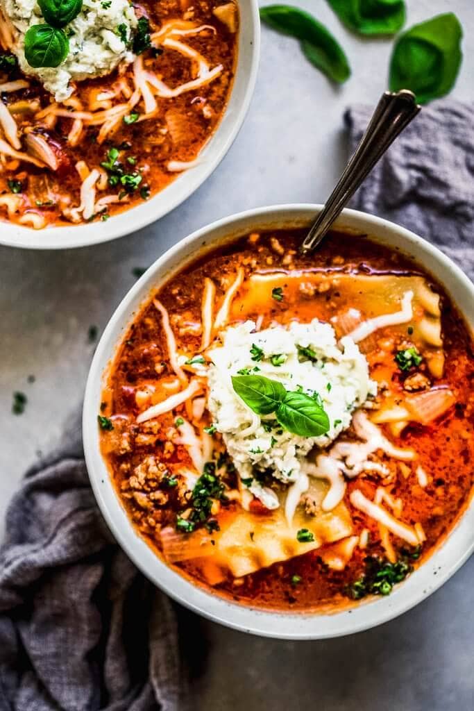Two bowls of lasagna soup on counter. 