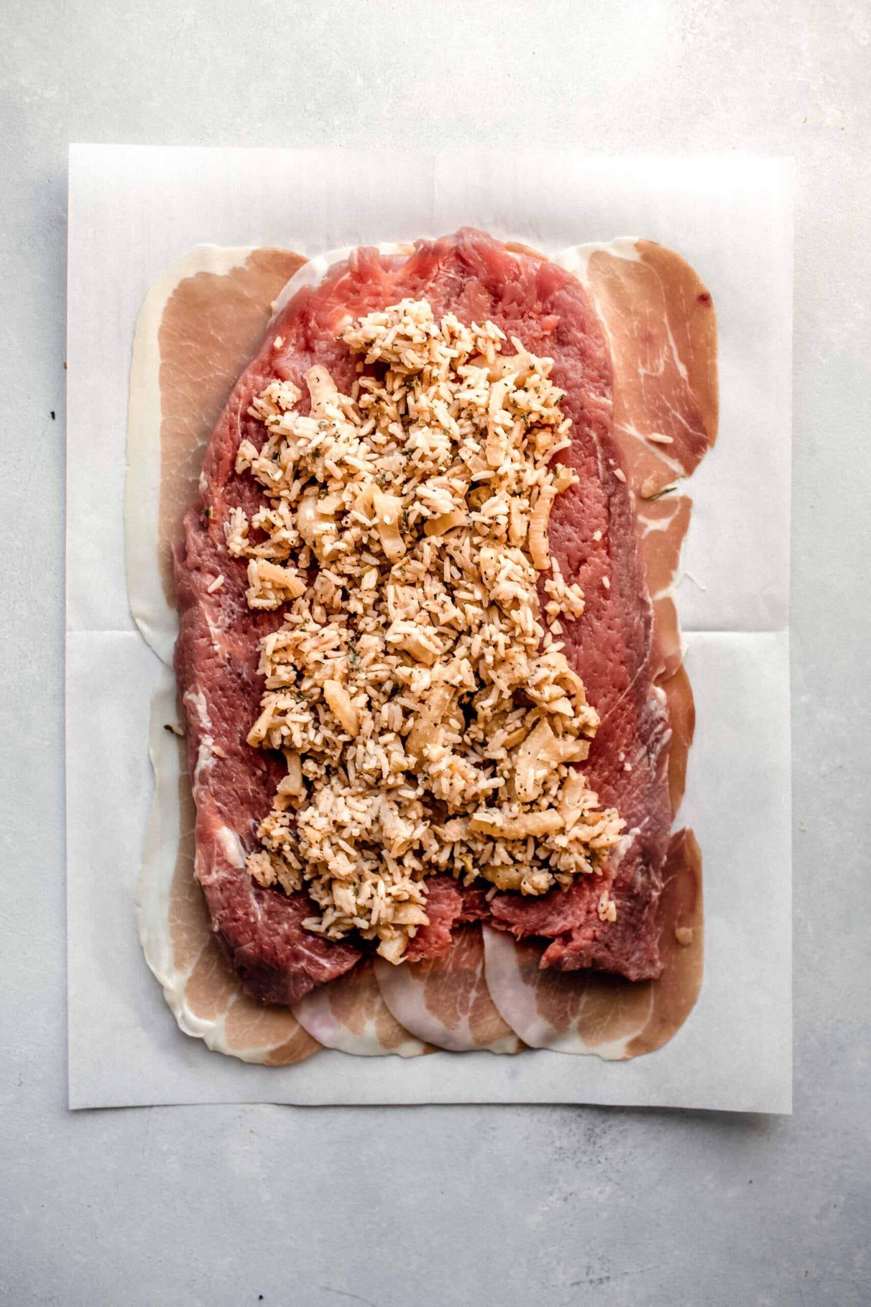 Pork loin on parchment filled with stuffing.