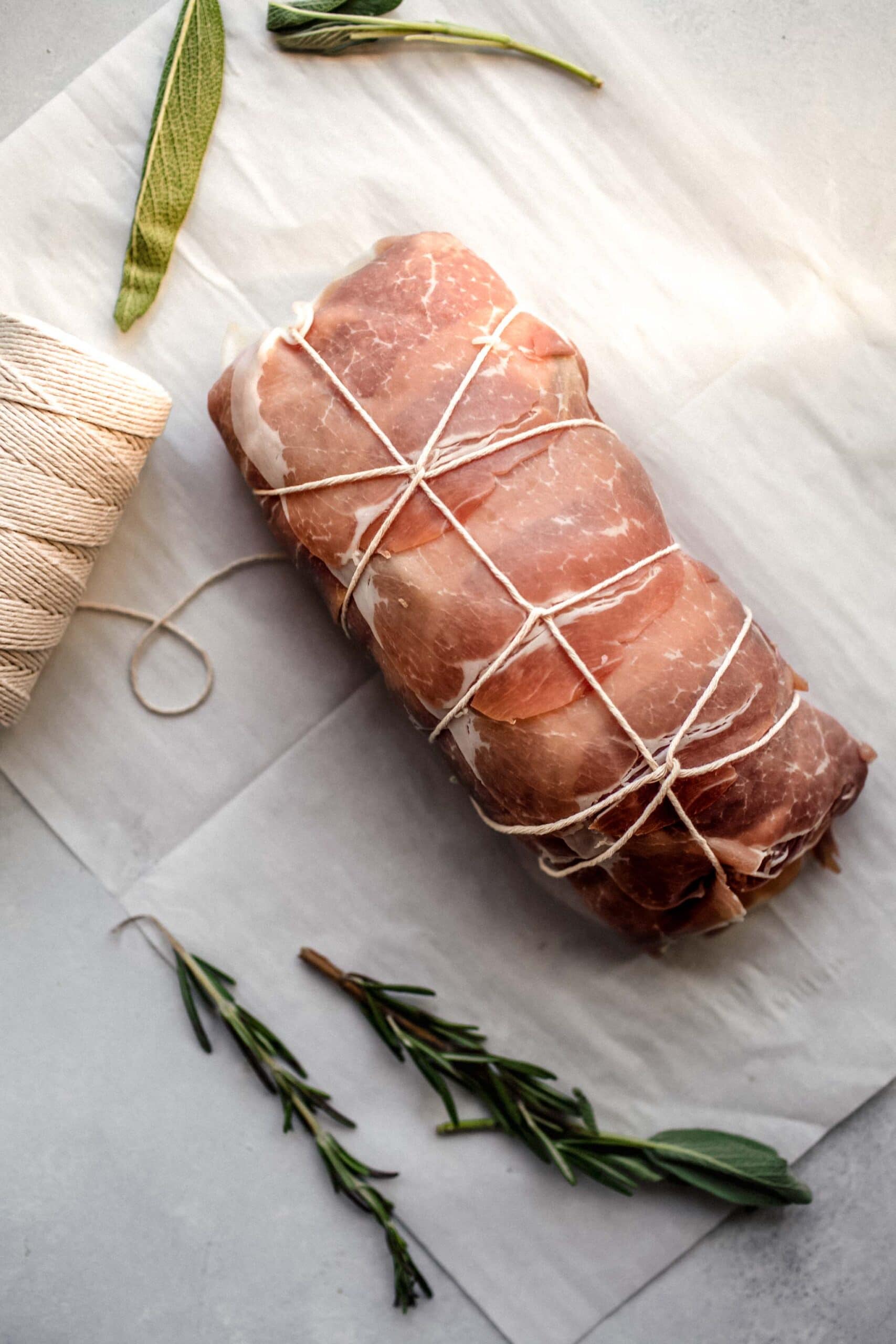 Wrapped pork loin tied with twine.