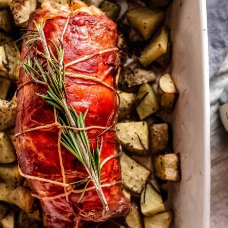 Baked pork tenderloin wrapped in prosciutto.