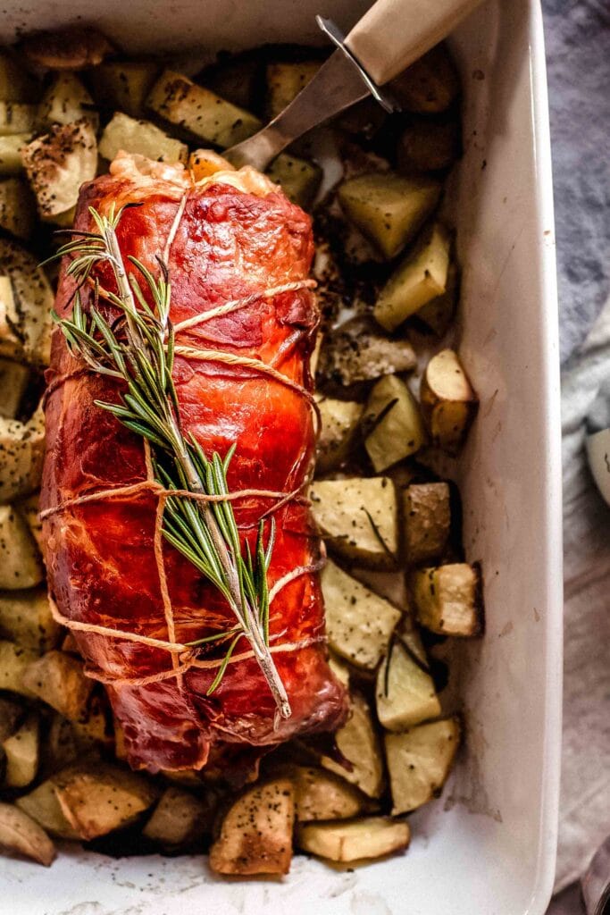 Baked pork loin wrapped in prosciutto.