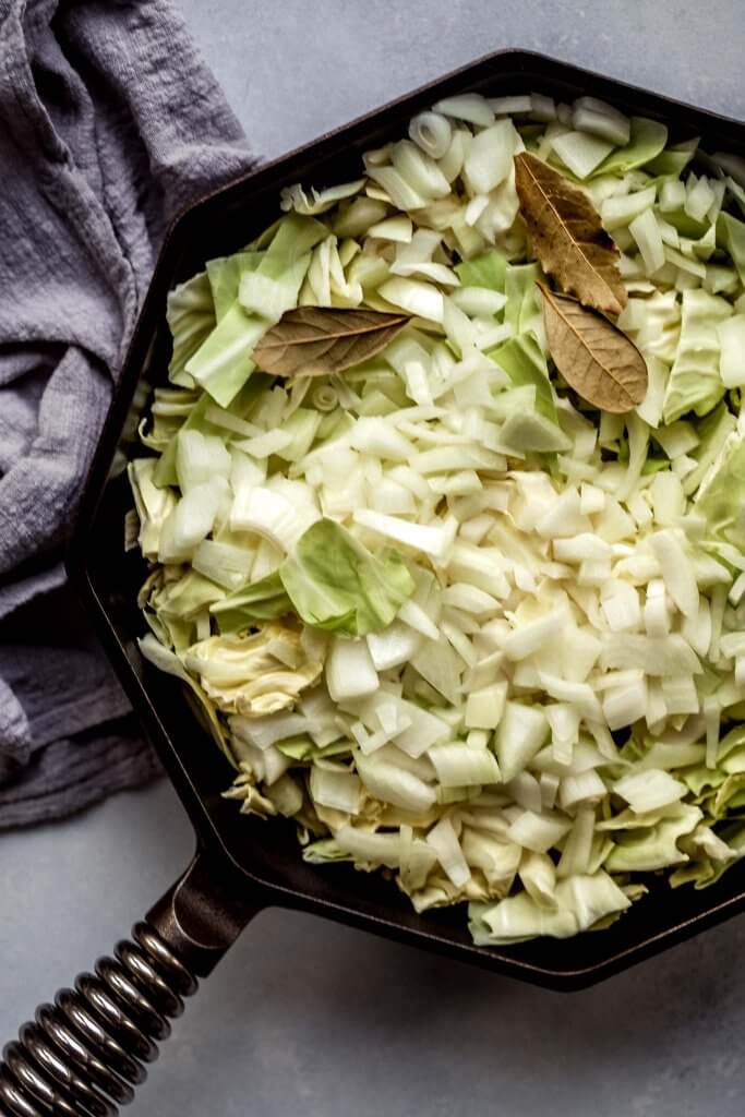Chopped cabbage in skillet.