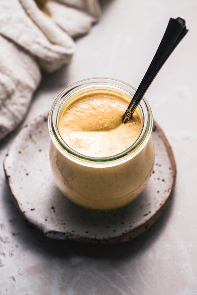 Cafe yumm sauce in small glass jar.