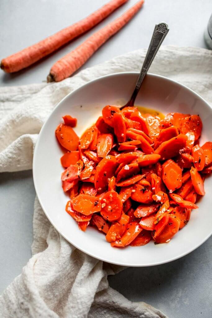 Overhead shot of bowl of glazed carrots. 