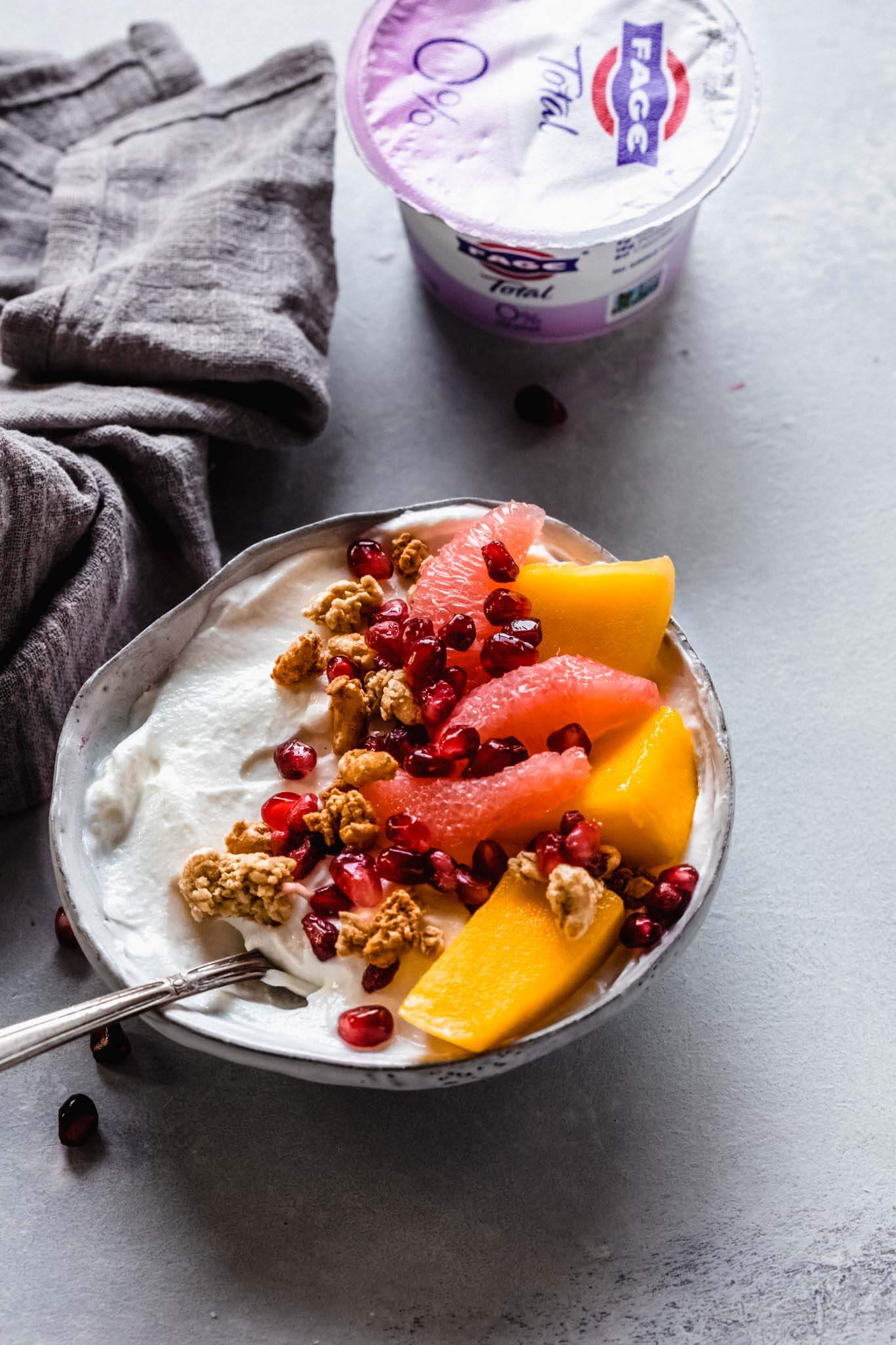 Yogurt topped with mango, grapefruit, granola & pomegranate.