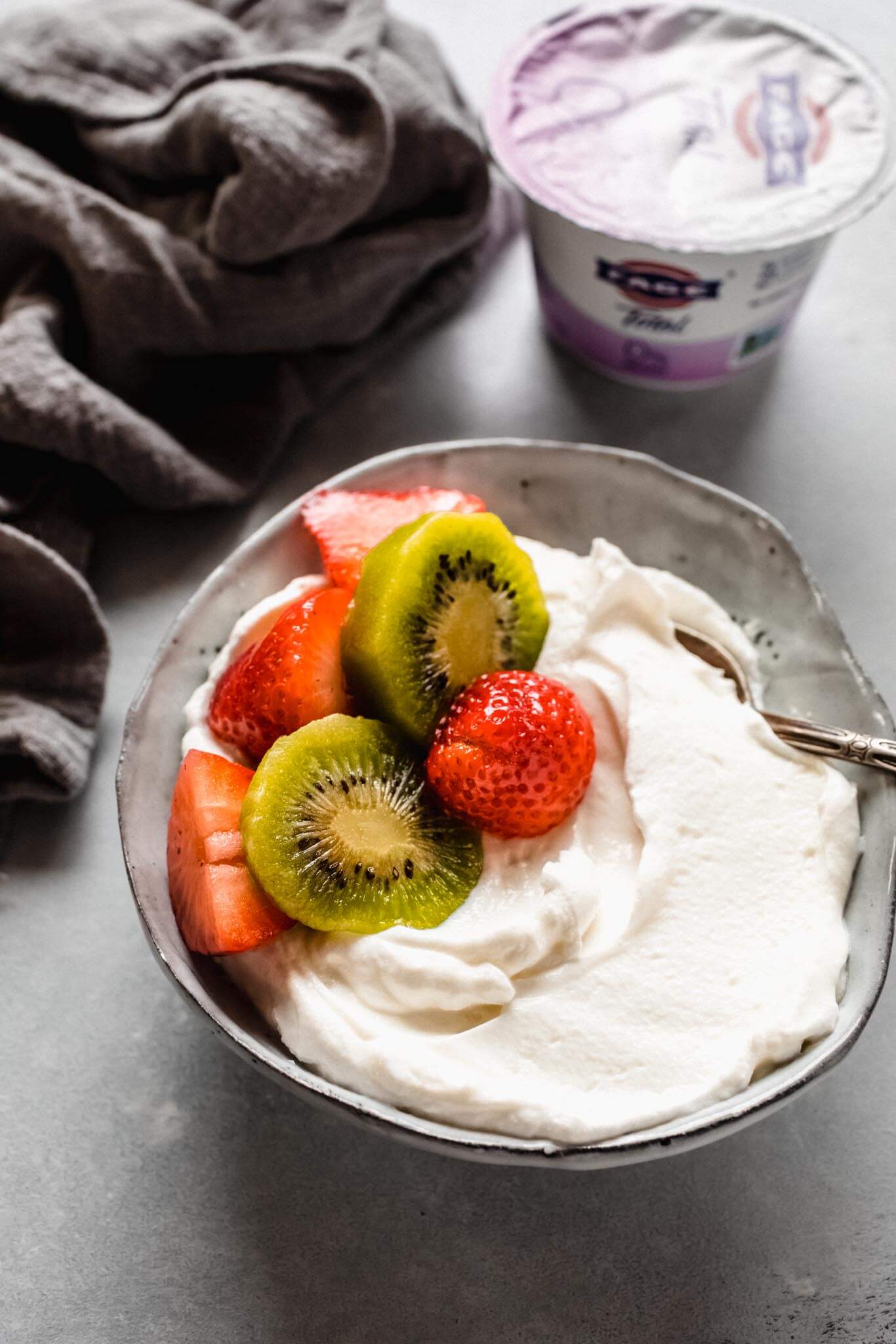 Yogurt topped with kiwi & strawberries.