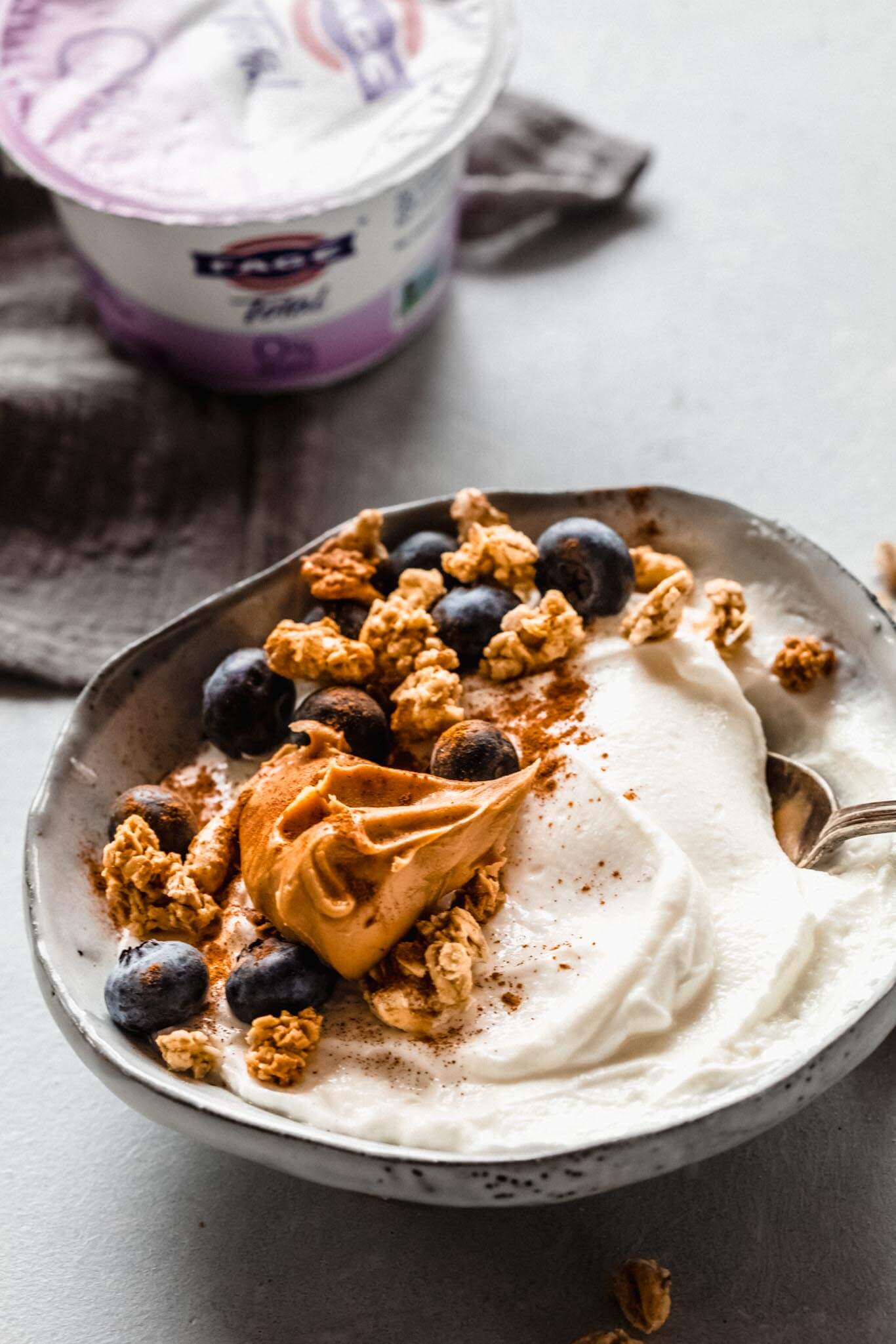 Yogurt topped with peanut butter, blueberries & granola.