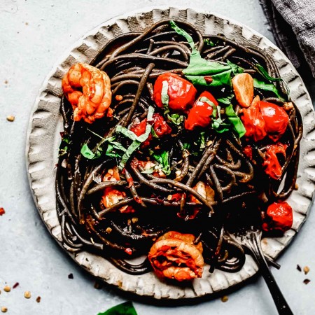 Overhead shot of plate of squid ink pasta.