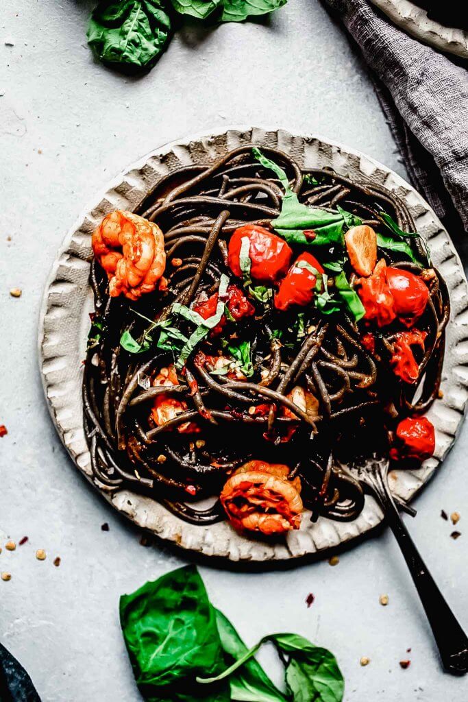 Overhead shot of plate of squid ink pasta.