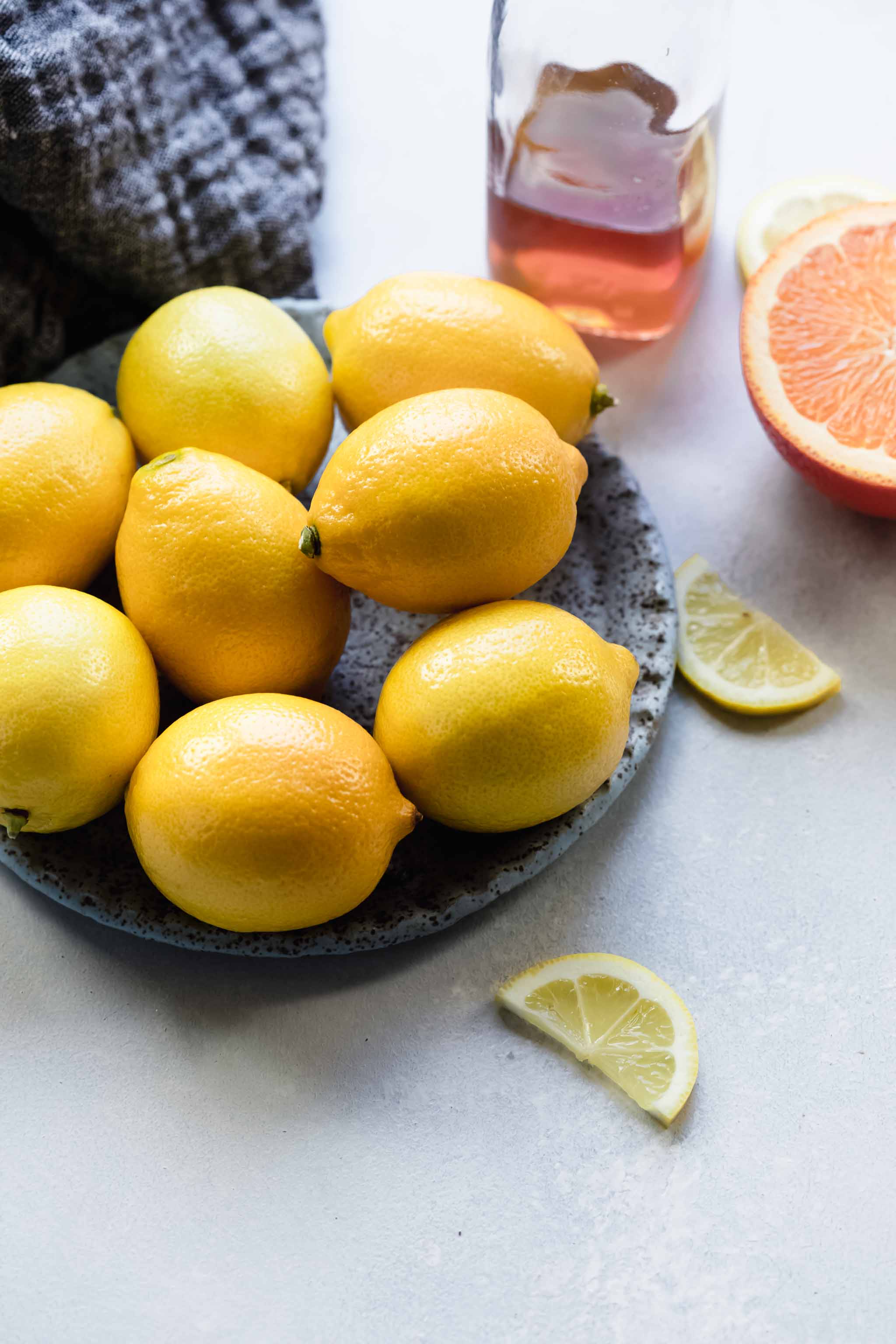 Bowl of lemons next to honey simple syrup.