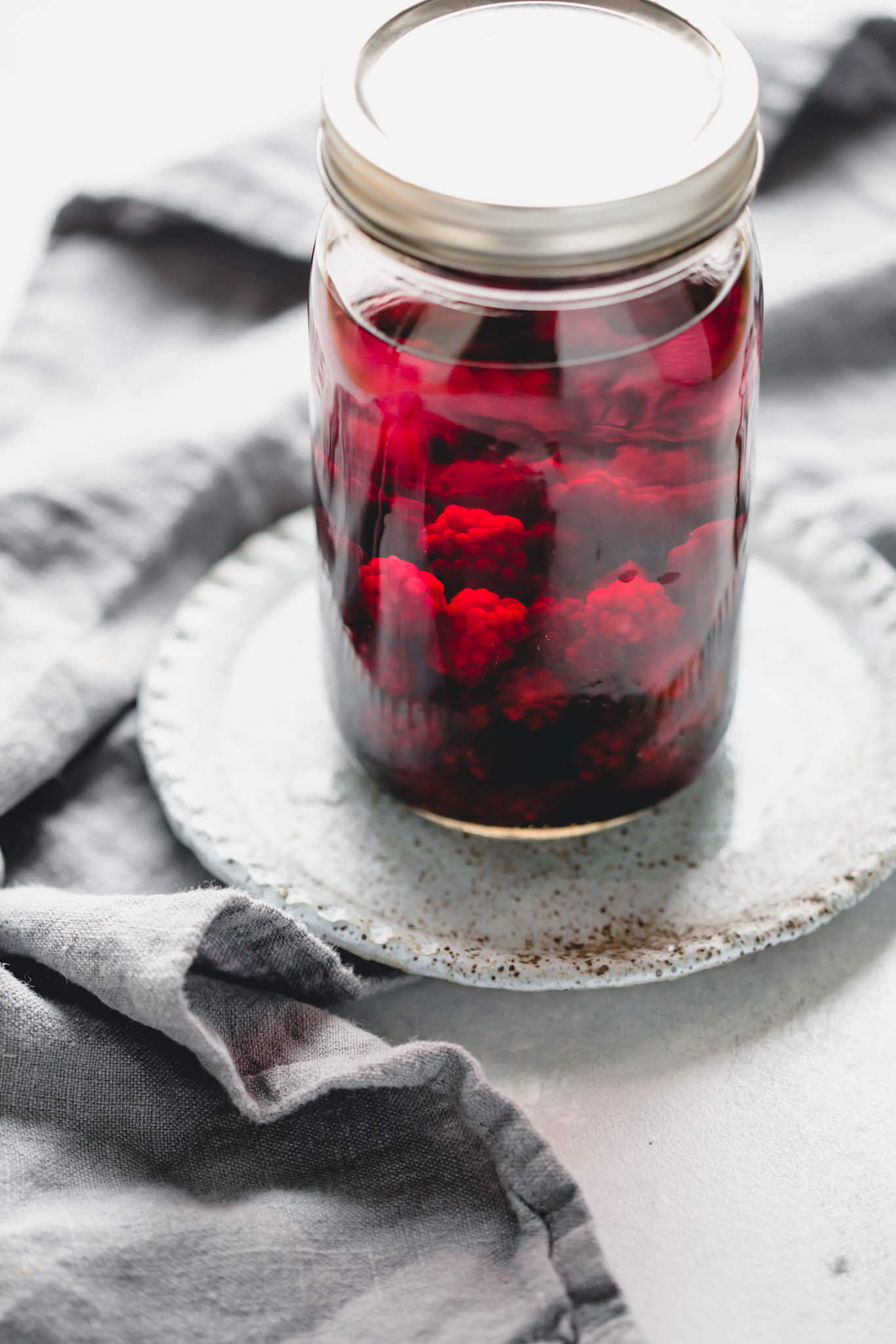 Jar of vodka with blackberries.