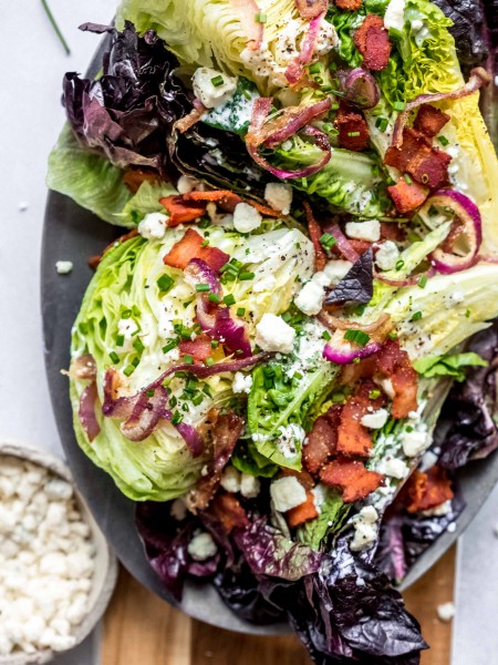 This Healthy Wedge Salad is topped with a lower-calorie tangy buttermilk-blue cheese dressing and combines iceberg lettuce with radicchio and romaine. It’s topped with crispy onions and bacon for added crunch.