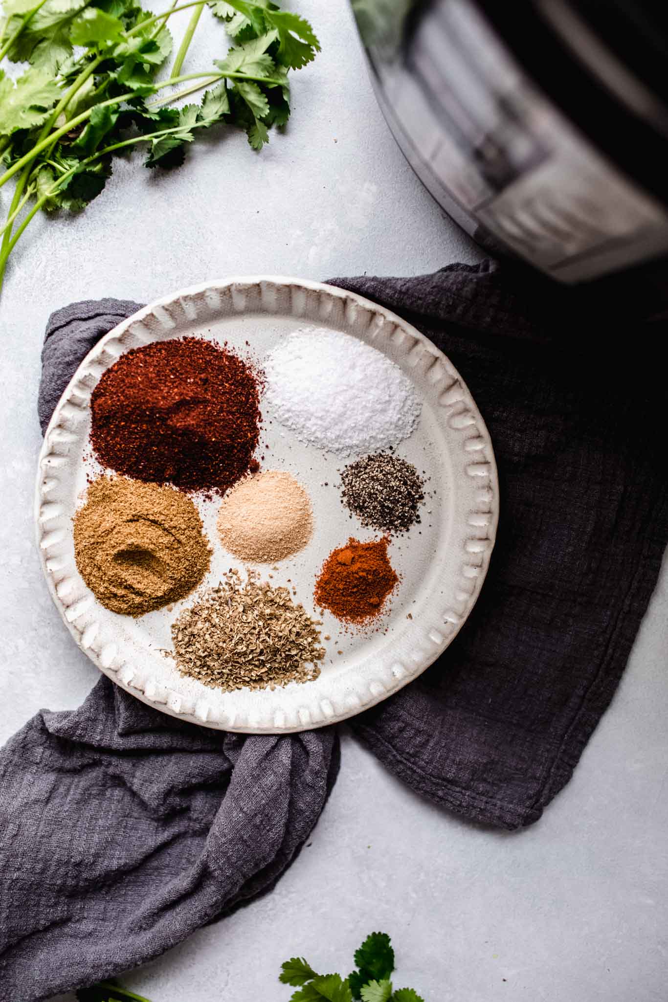 Spices for chili next to instant pot.
