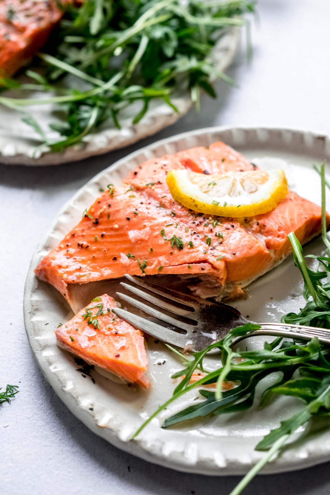 Piece of instant pot salmon with bite taken out of it.