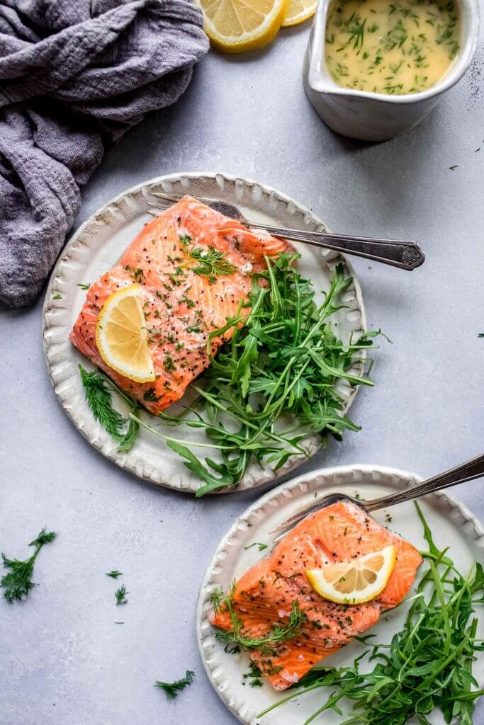Two plates of cooked salmon.