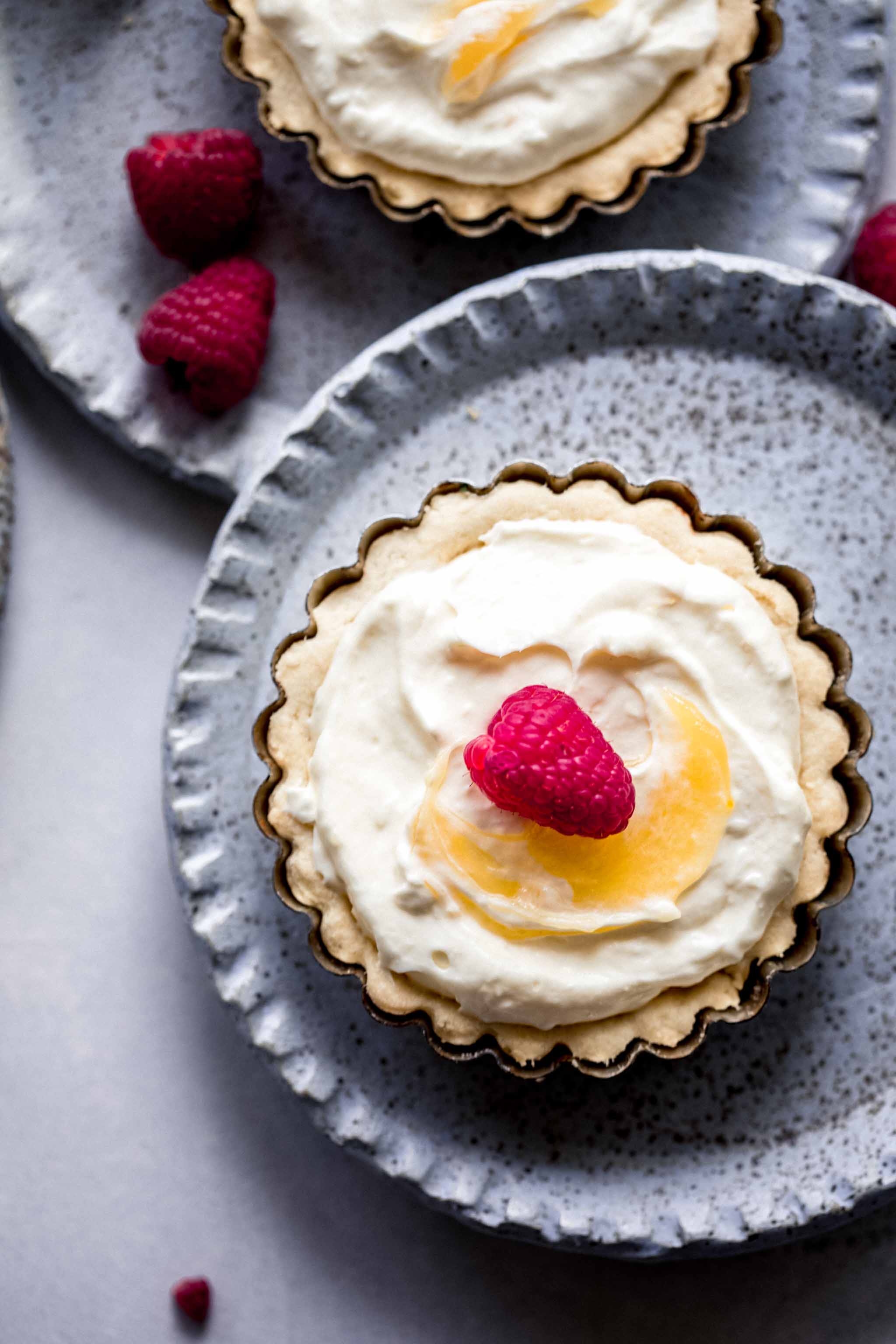 Overhead close up of Lemon Tartlet topped with raspberry.
