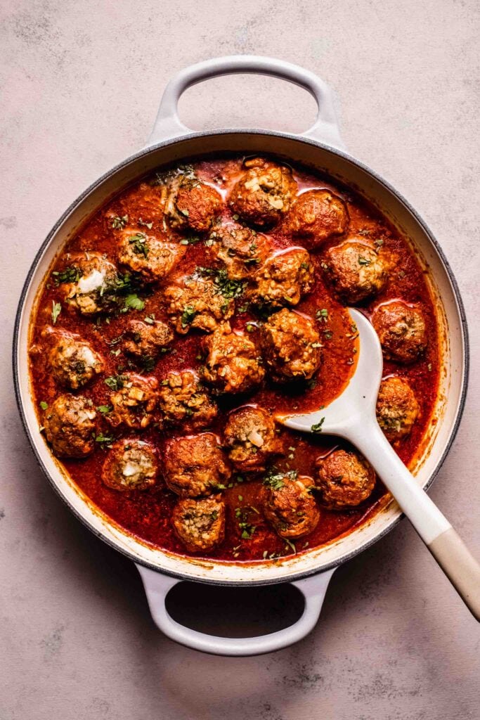 Simmered meatballs in skillet. 