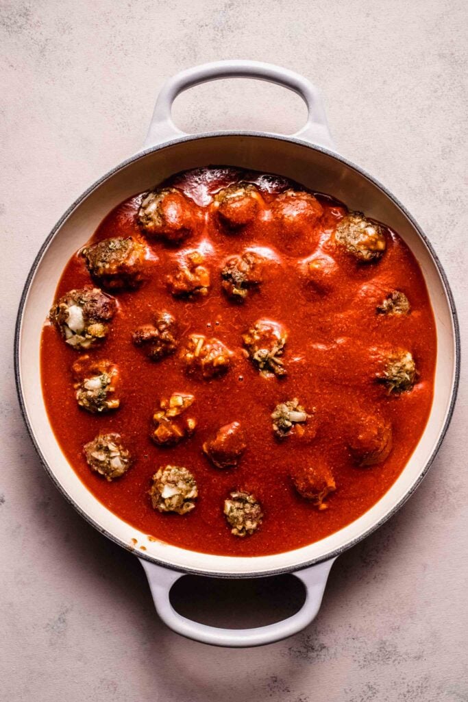 Sauce poured over meatballs. 