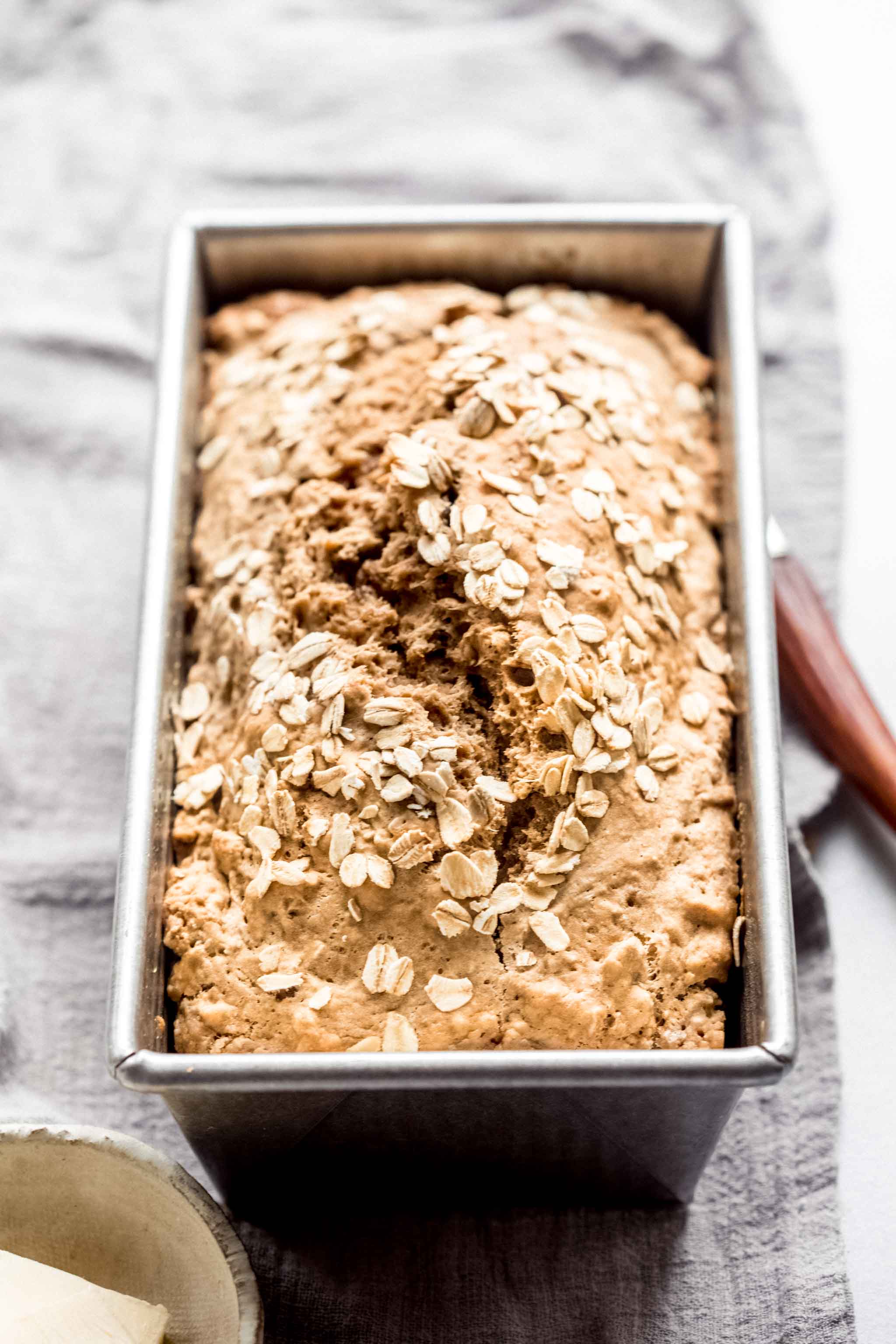 Side view of cooked guinness bread in loaf pan.