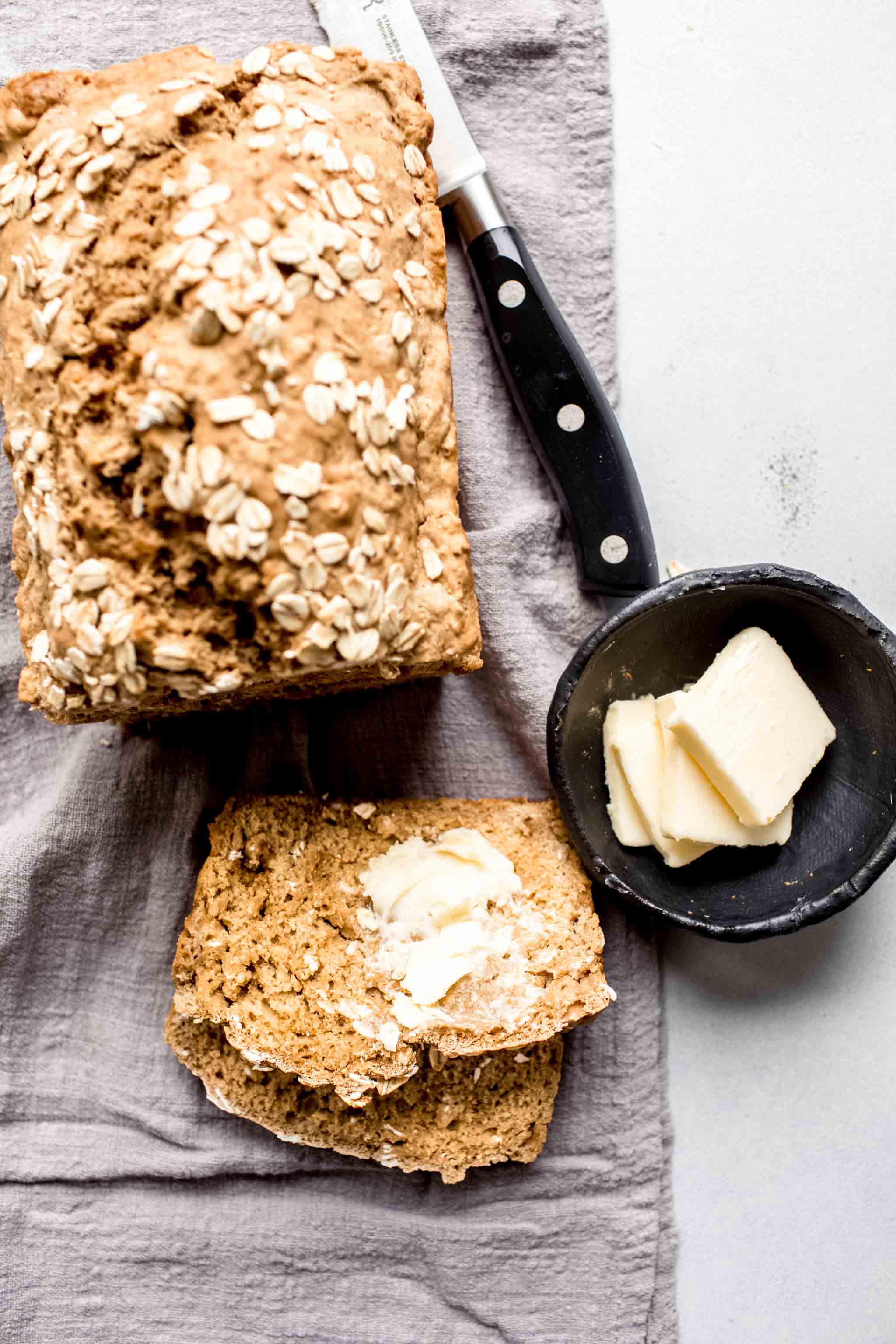 Sliced guinness bread spread with butter.