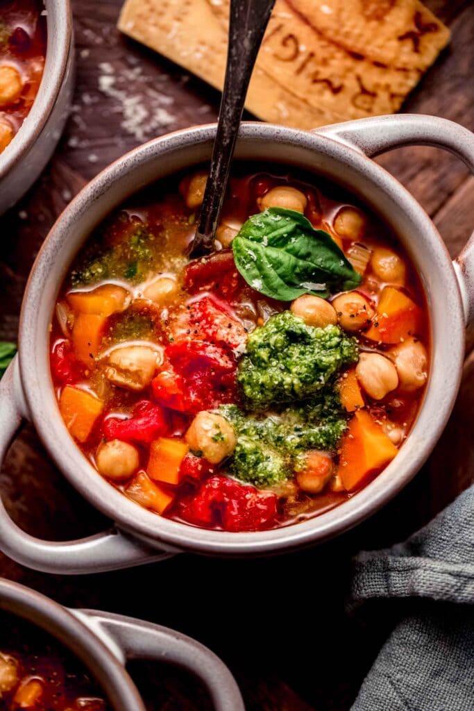 Overhead close up of bowl of soup topped with pesto.