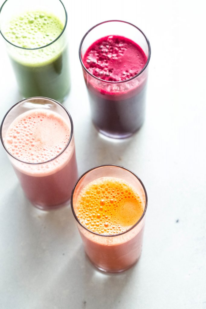Five different colorful juices in a row.