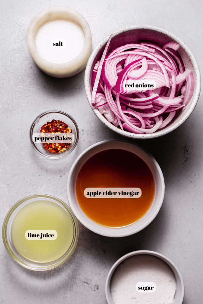 Ingredients for pickled onions labeled on counter. 