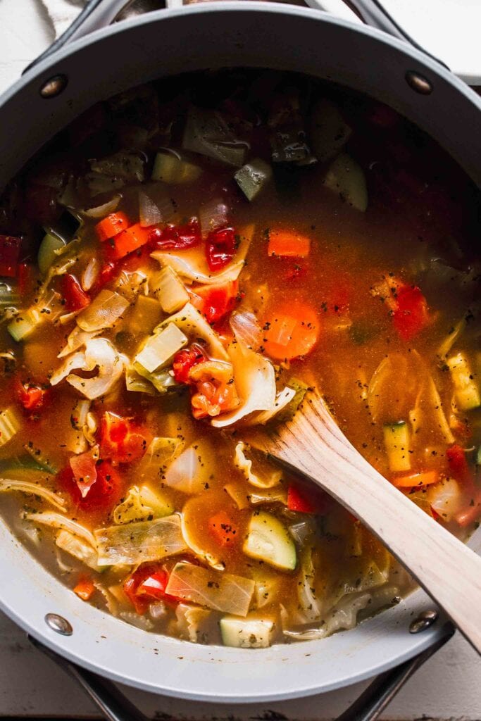 Cooked cabbage soup in large pot.