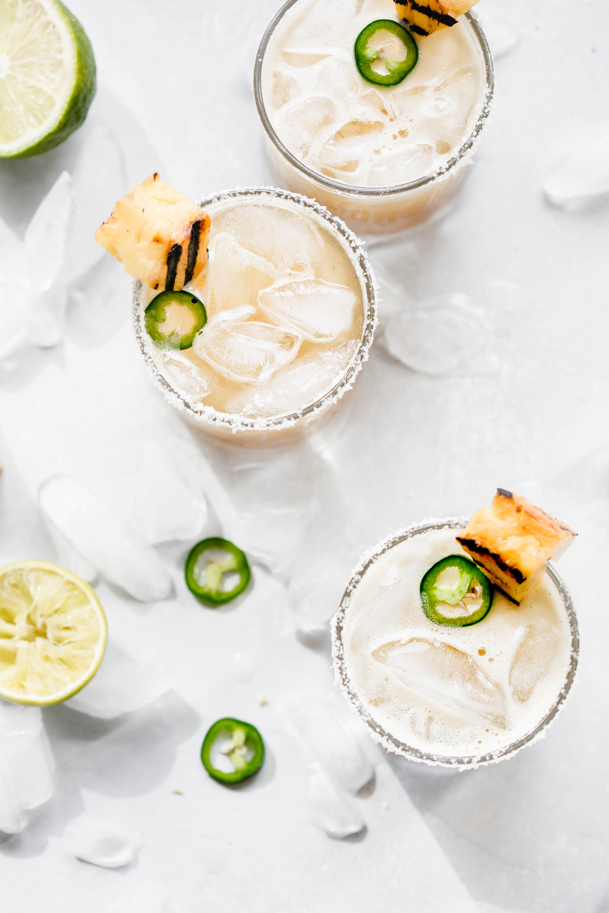 Overhead shot of three grilled pineapple margaritas.