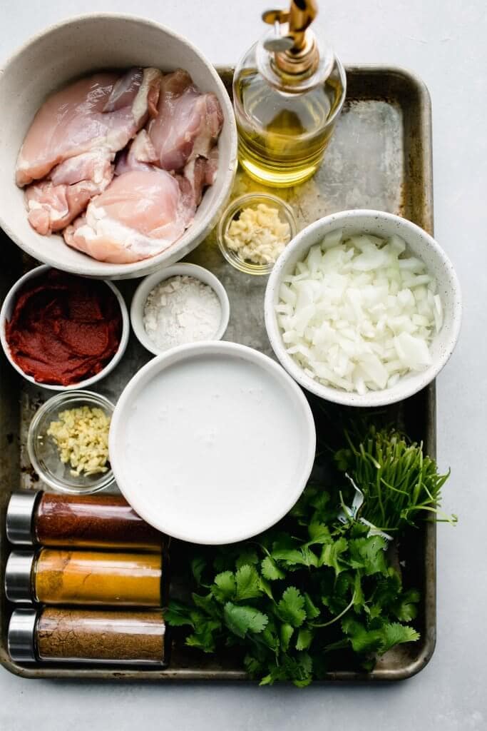 Ingredients for instant pot butter chicken laid on tray.