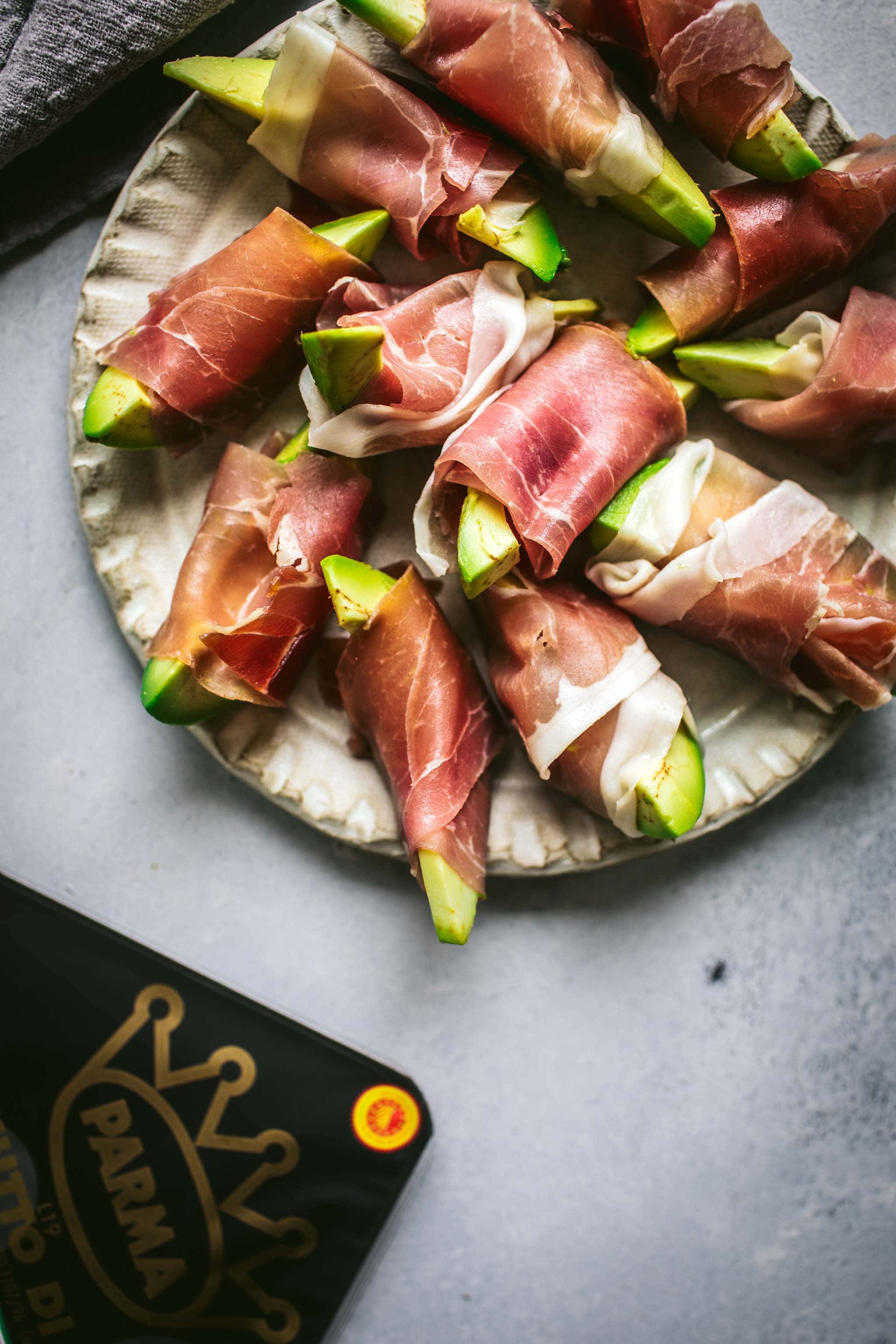 Plate of Avocado bites wrapped in prosciutto.