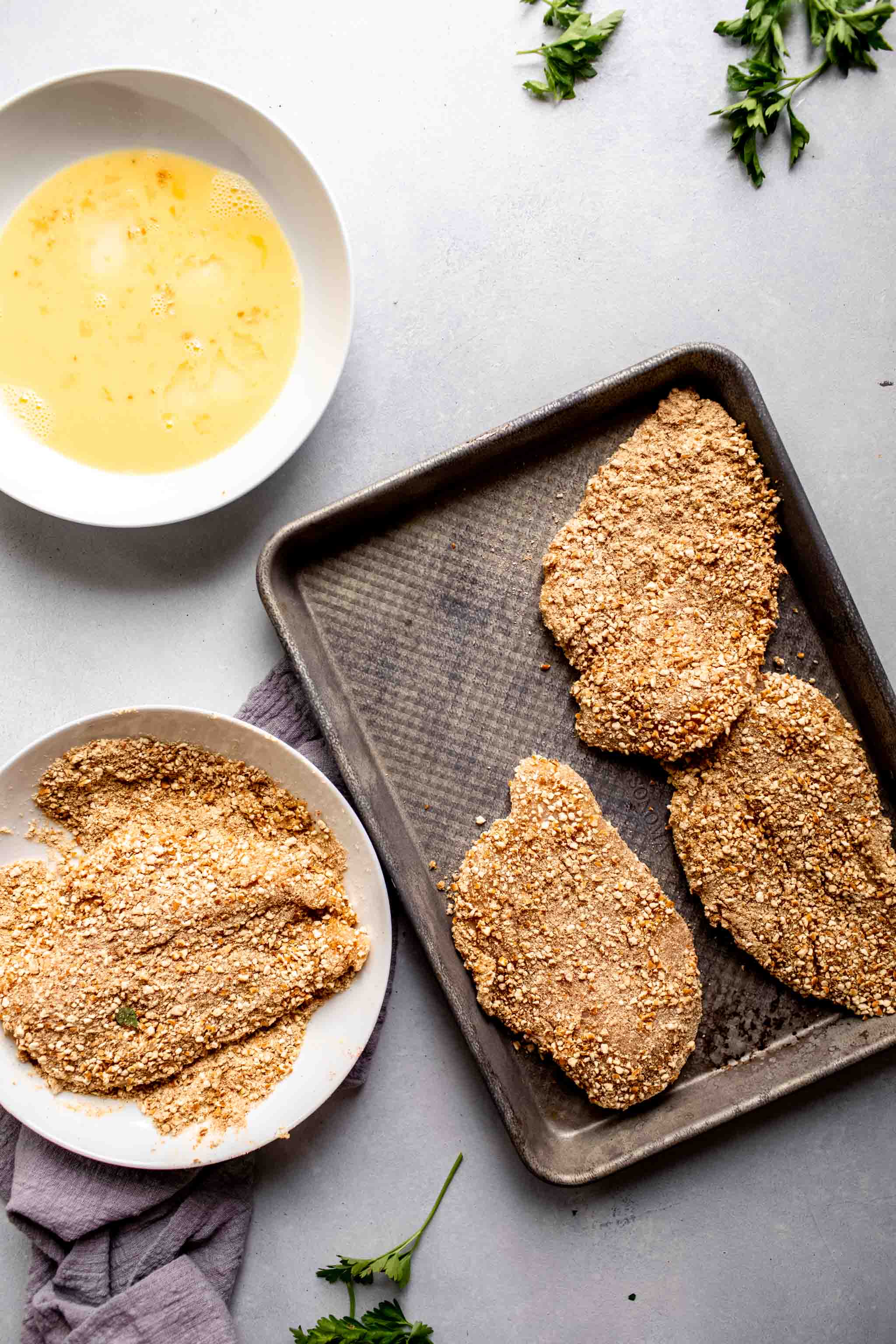 Chicken breasts coated with pretzels before frying.