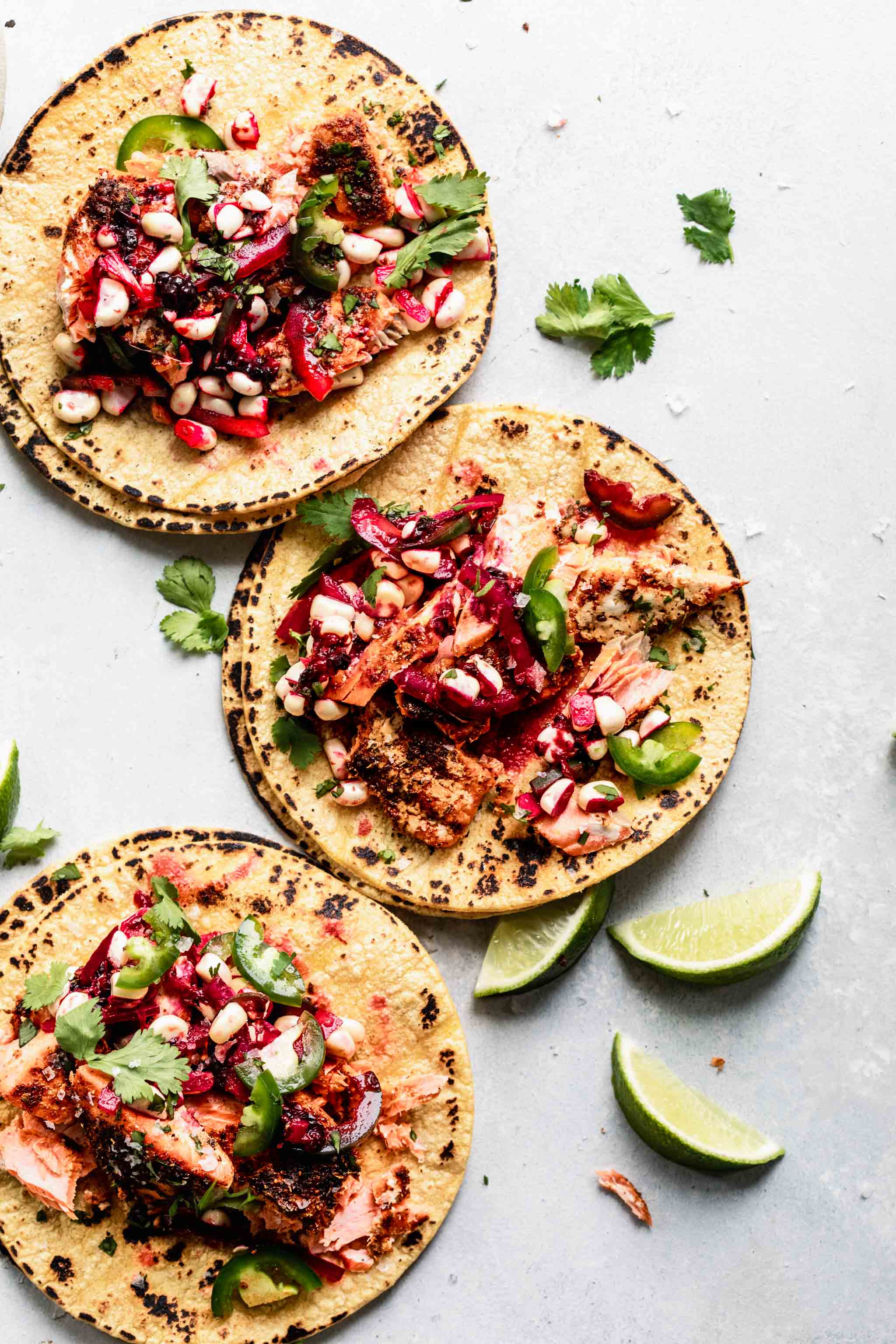 Overhead shot of three assembled salmon tacos.