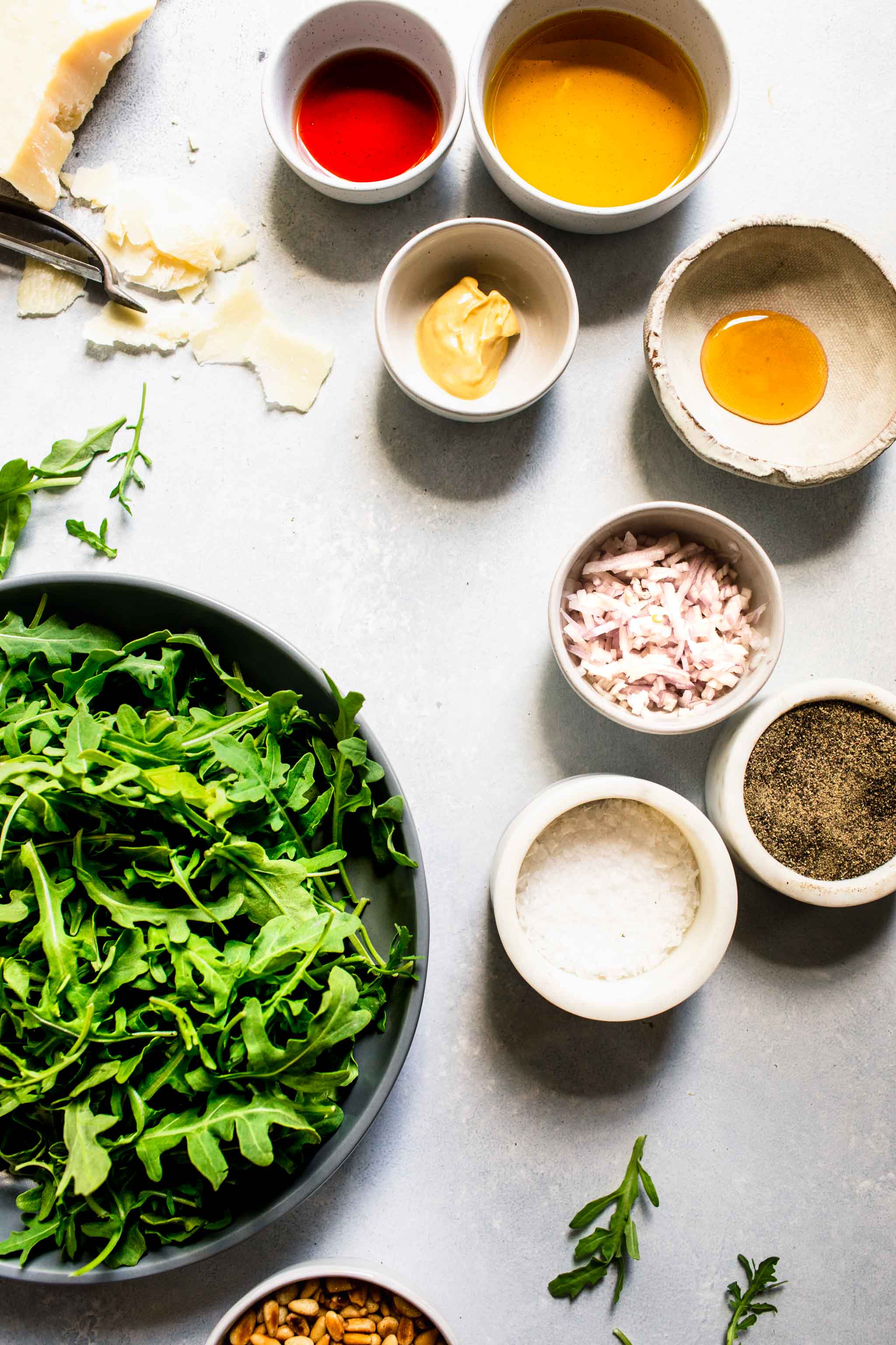 Ingredients for arugula salad laid out on table.