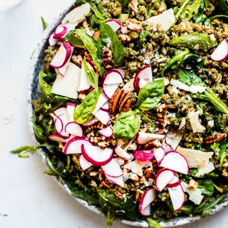 Pesto Farro Salad in bowl topped with radishes and pecans.